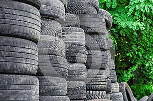 Old used car tires stacked in stacks