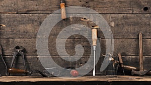 Old used carpenter tools on wood