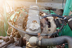 Close-up of an old used diesel engine with rusty and dirty car parts, water infiltration and poor car maintenance