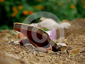 Old used foot sleeper lying on soil field