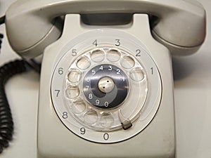 Old used telephone with rotary dial