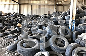 Old used tires piled up in junkyard