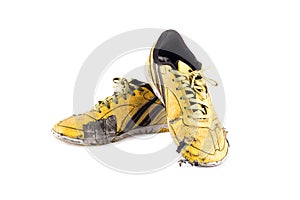 Old used  yellow worn out futsal sports shoes  on white background soccer sportware object isolated