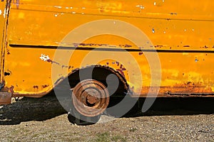 Old van resting on blocks is missing a tire