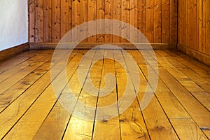 Old varnished wooden floor and wall of room