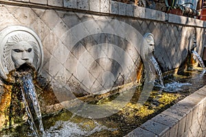 Old venetian fountain with lions heads in Spili, Crete island, Greece