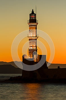 Old Venetian lighthouse with a colorful sunset (Chania, Crete, Greece