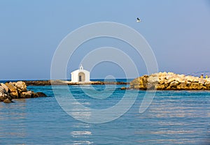 Old venetian lighthouse at harbor in Crete, Greece. Small cretan village Kavros.