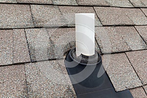 Old vent pipe flashing boot on roof of house.