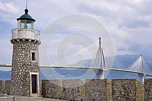 Old versus new, aged lighthouse versus modern cable bridge
