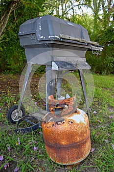 Old & very rusty propane canister and outdoor grill