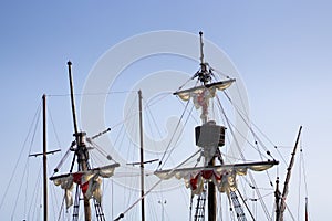 Old vessel boat wooden masts, folded white sails