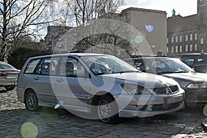 Old veteran vintage classic dented Japanese car Mitsubishi Carisma hatchback