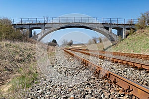 Old viaduct over the railway tracks. Concrete bridge over the railroad