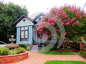 Old victorian house yard with brick pavement Myrtle tree