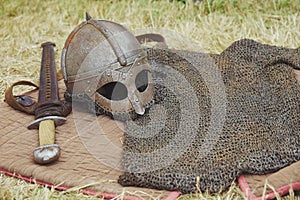 Old Viking armor on yellowed grass. Viking Festival