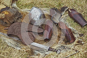 Old Viking armor on yellowed grass. Viking Festival