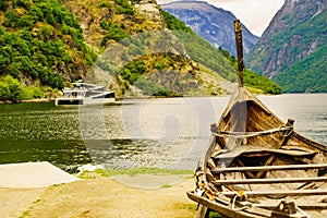 Old viking boat and ferryboat on fjord, Norway