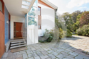 Old villa with garden, entrance and elevator in a sunny day, clear blue sky