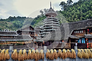 An old village of minority in Guizhou province in China with traditional drum tower in the background.