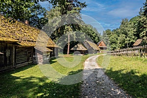 An old village wooden white house from 19th century with thatched roof.