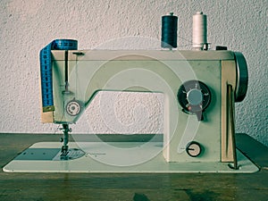 Old vinatge romanian sewing machine with sewing thread. Tailoring meter on a sewing machine