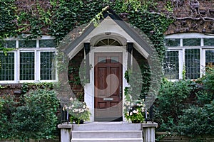 Old vine covered house with leaded glass windows