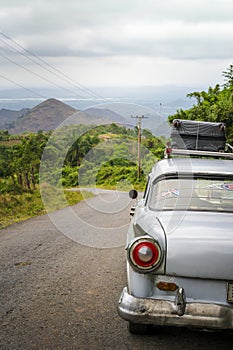 Old vintage American car on a road outside Trinidad