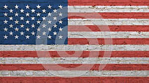 Old vintage American US flag over brick wall