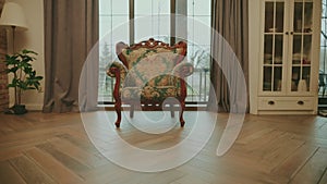 old vintage antique chair armchair stands in classic interior room, panoramic French large window. wooden furniture