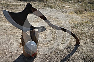 Old vintage axe on a wooden block ready to cut head