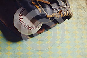 Old vintage ball in leather mitt, grunge baseball equipment image. Great for sports team or hardball player graphic.