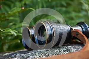 Old vintage binoculars with a leather strap