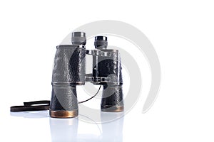 Old vintage binoculars on white background, reflections and shadows, Soviet binoculars WWII