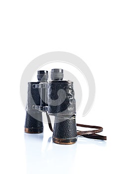 Old vintage binoculars on white background, reflections and shadows, Soviet binoculars WWII