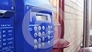 Old, Vintage Blue Telephone with Number Buttons in the Phone Booth