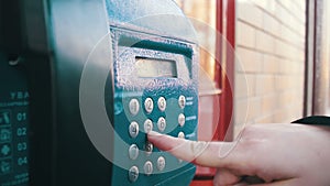 Old, Vintage Blue Telephone with Number Buttons in the Phone Booth