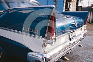 Old Vintage blue with white roof Plymouth Belvedere parked on the sideway on sunny day after the rain