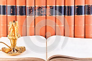 Old vintage books and candle close-up as a background