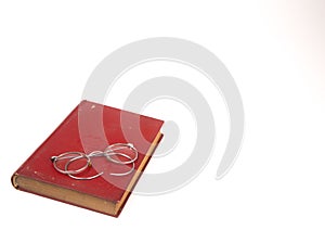 Old vintage books and glasses isolated on white background