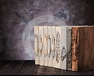 Old vintage books on a wooden shelf