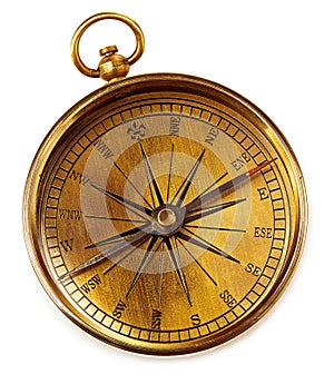 Old vintage brass compass isolated on a white background.