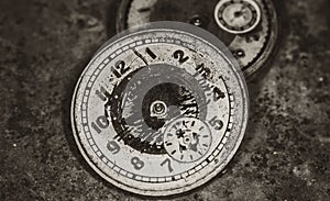 An old vintage broken mechanical watch. Dark grunge background