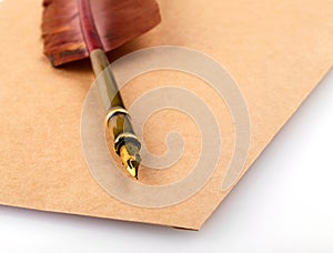 Old vintage burned envelope letter with quill feather pen on a white background