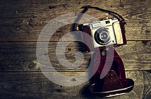 Old Vintage Camera on Dark Wooden Background. Horizontal with Co