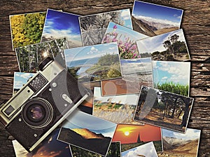 Old vintage camera and photos on a wooden background