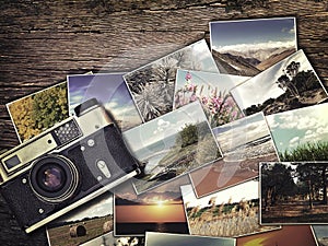 Old vintage camera and photos on a wooden background