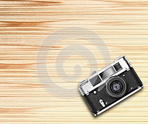 Old vintage camera on wooden background