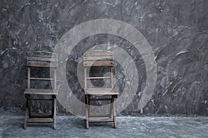 Old vintage chair wooden at dark concrete wall