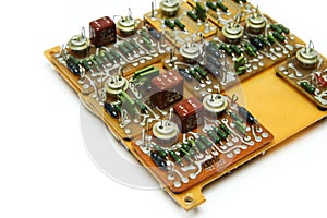 The old vintage circuit board with several electronic components.